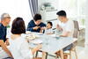 a group of people sitting at a table eating food